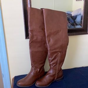 Over the knee brown leather boots.